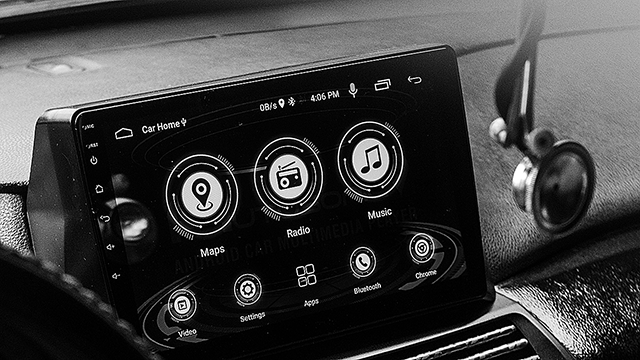 A vehicle touch display console that shows digital dials for radio, navigation and music.